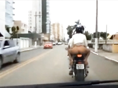 Girl in a skirt on motorcycle shows her ass