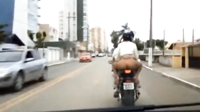 Girl in a skirt on motorcycle shows her ass