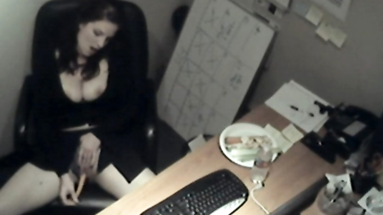 Busty business woman fucks a carrot at work