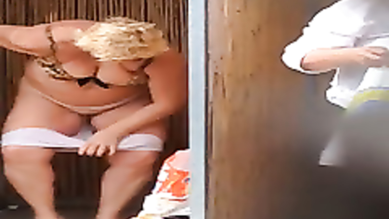 Fat mature lady changing at the beach