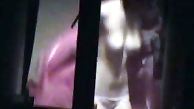 Topless girl filmed through her bedroom window voyeurstyle