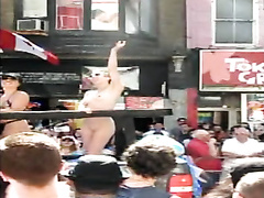 Undressed girl with small tits on a parade float