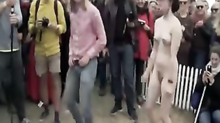 Nude man and woman learn to line dance for a crowd