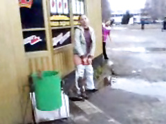 Girl caught peeing outside a store as he laughs