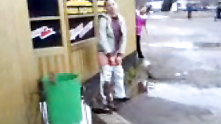 Girl caught peeing outside a store as he laughs