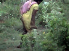 Indian women pissing in the grass in voyeur video