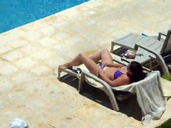 Bikini brunette caught masturbating her pussy poolside