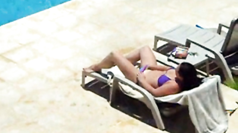 Bikini brunette caught masturbating her pussy poolside