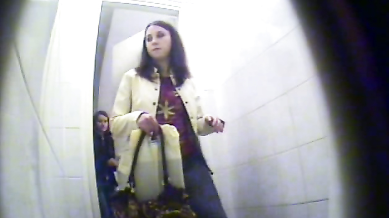 Spy cameras in restroom film girl pissing