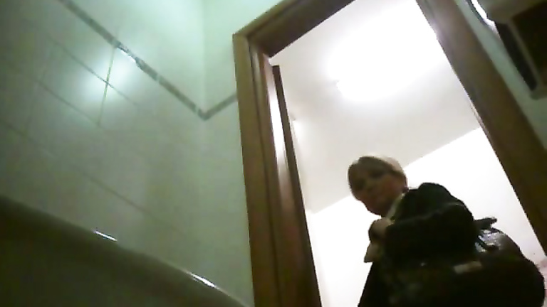Classy blonde mature urinates in public bathroom video