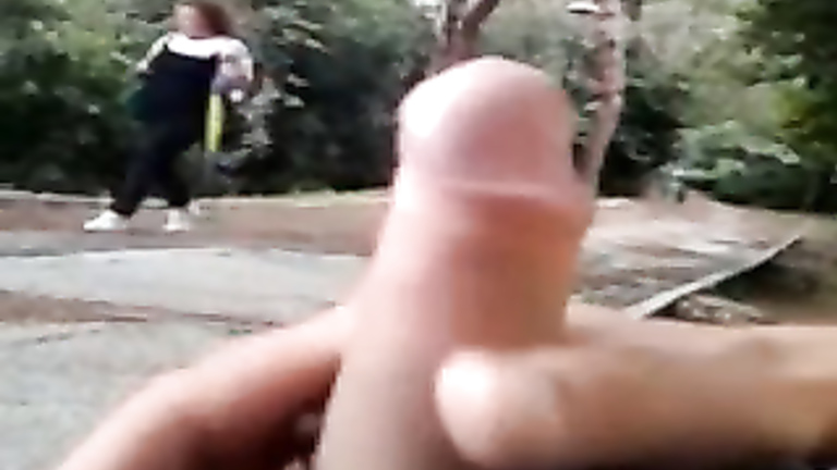 Masturbating on a park bench as a casual girl walks by