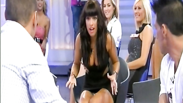 Busty babe on reality show gives upskirt flashes