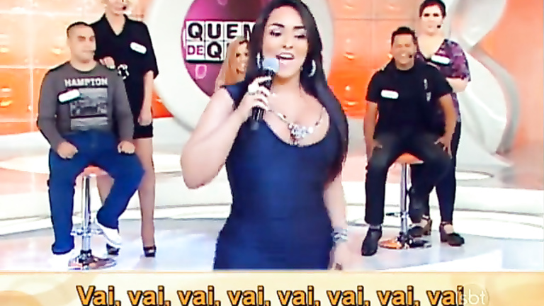 Chubby Latina in a tight dress sings on TV show