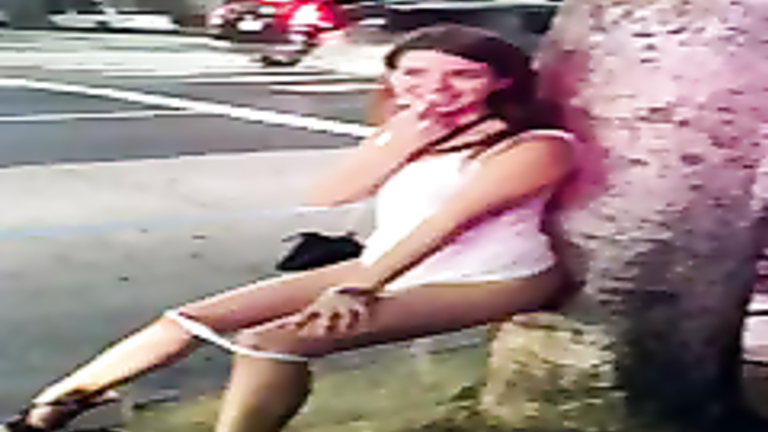 Sexy teen girlfriend peeing against a tree in public