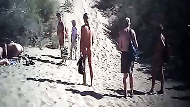 French swingers fuck on the nude beach as people watch voyeurstyle image