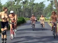 Nudist women take a bike ride to the beach