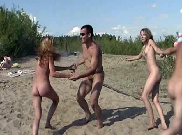 Nudist beach party with fun dancing voyeurstyle image