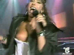 Italian popstar sings and her big tit pops out