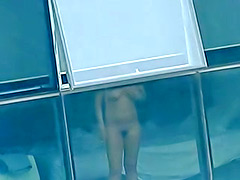 Naked amateur stands in front of the window
