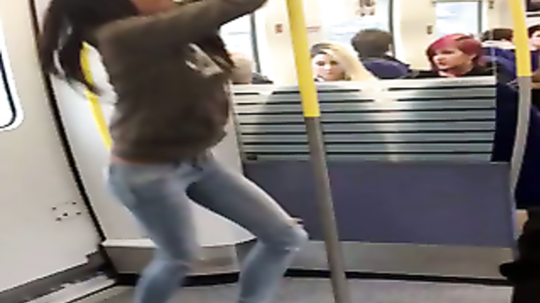 Playful college chick pisses on the subway platform