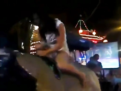 Babe rides the bull and reveals the ass and tits