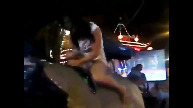 Babe rides the bull and reveals the ass and tits