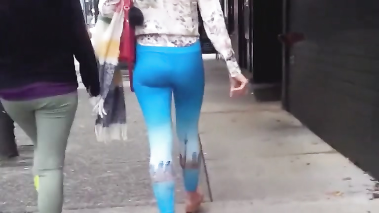 Blue spandex hugs her ass on the city street