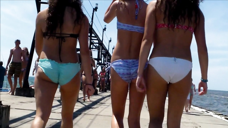 British coed girls on a vacation wear tight bikinis to the beach