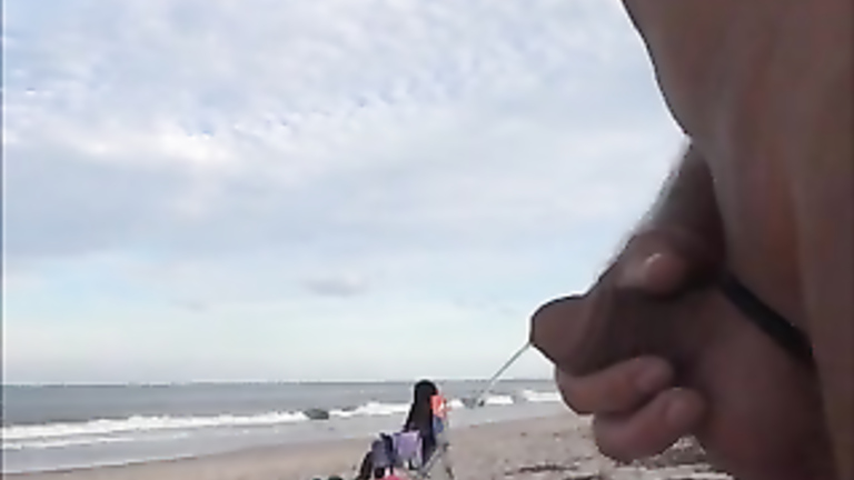 Horny daddy pisses and jerks off his penis on a black babe at the beach