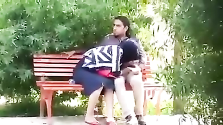 Turkish girl in hijab gives a blowjob to her friend in the city park voyeurstyle