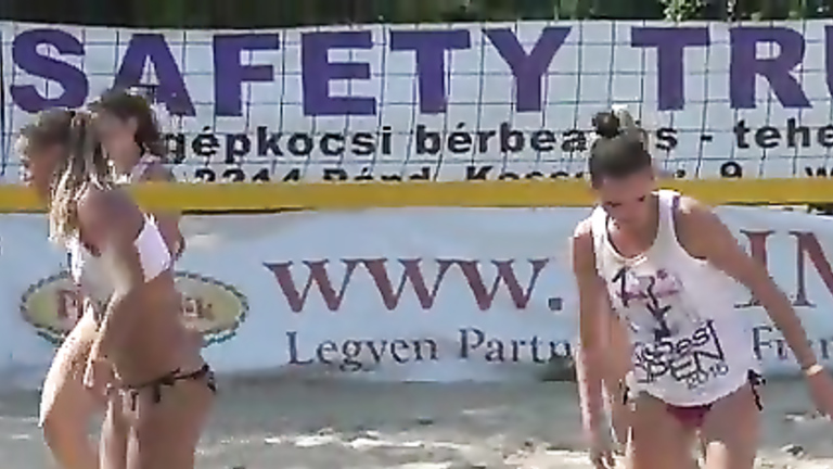 Stunning babes enjoy playing a match of beach volleyball