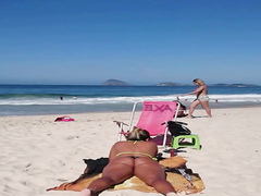 Tanned cutie has her big butt recorded on the beach of Rio de Janeiro