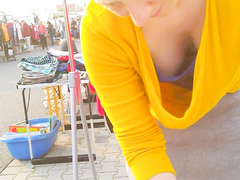 Street market seller has her big cleavage caught on the camera