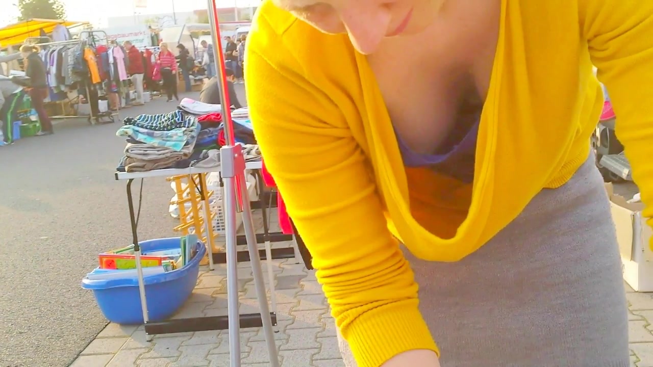 Street market seller has her big cleavage caught on the camera voyeurstyle