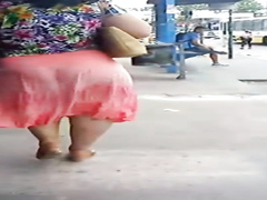 Latina woman with a very large booty walks around the town