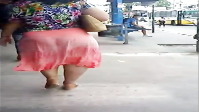 Latina woman with a very large booty walks around the town