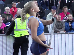 Hot blonde pole vaulter competes at a packed stadium