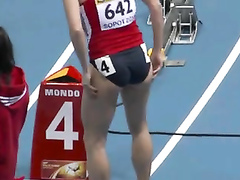 Athletic woman runs around the track in a flimsy outfit