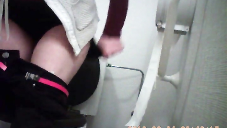 Lovely coed gets taped peeing hard in a public WC
