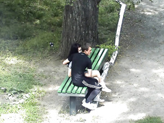 Russian lovers kiss and caress each other in the city park