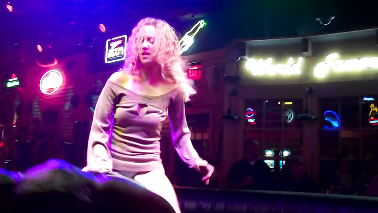 Riding the mechanical bull uncovers blonde's sexy ass
