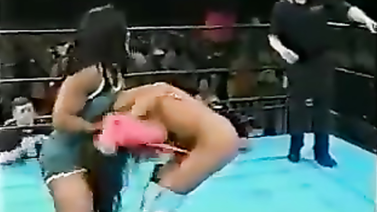 Brunette with visible boobs in the wrestling ring