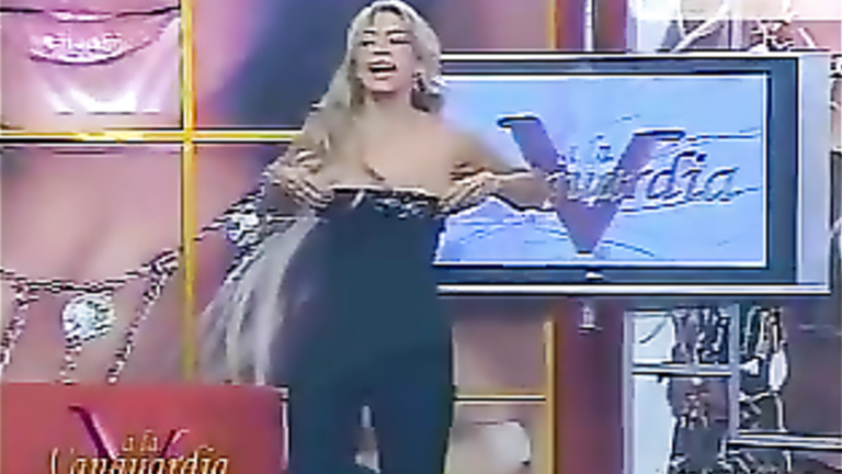 Busty TV host barely keeps her tits in her shirt