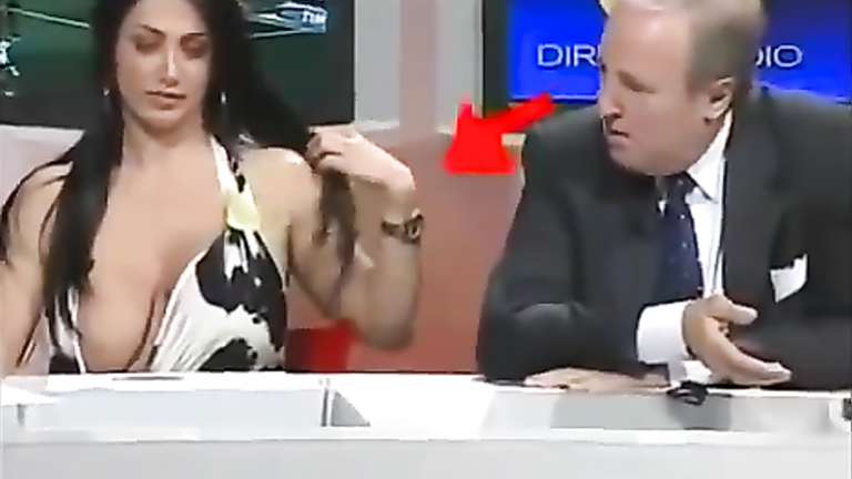 Famous Italian TV host with large boobs desperately tries to keep them in her dress