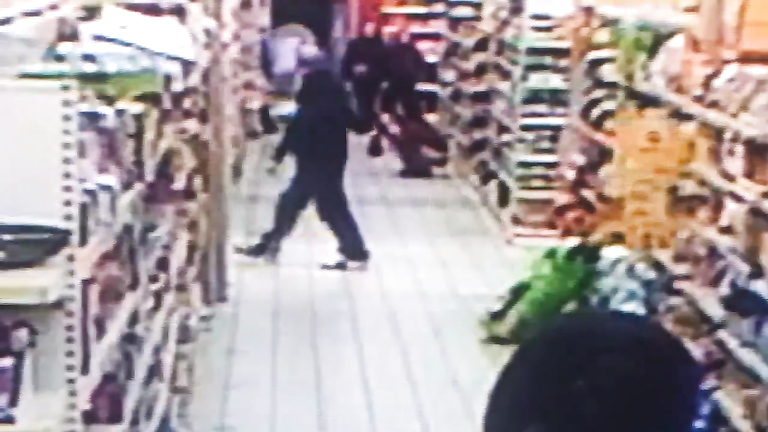 Impudent brunette urinates in the middle of the supermarket floor