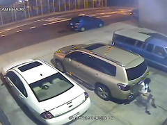 Security camera catches a girl peeing behind a car