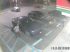 Desperate black woman soaks the parking lot next to the car