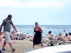 Crazy woman decides to piss on the beach sand