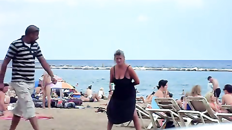 Crazy woman decides to piss on the beach sand