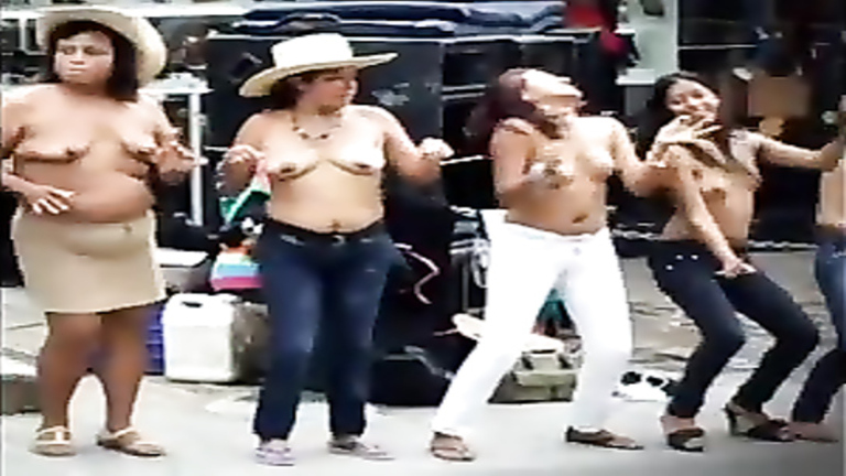 Busty Latina women dancing topless on the street